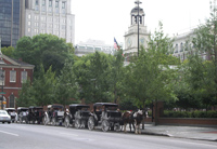 Horse drawn carriages await visitors seeking leisurely tours around the historic sites of the Old City